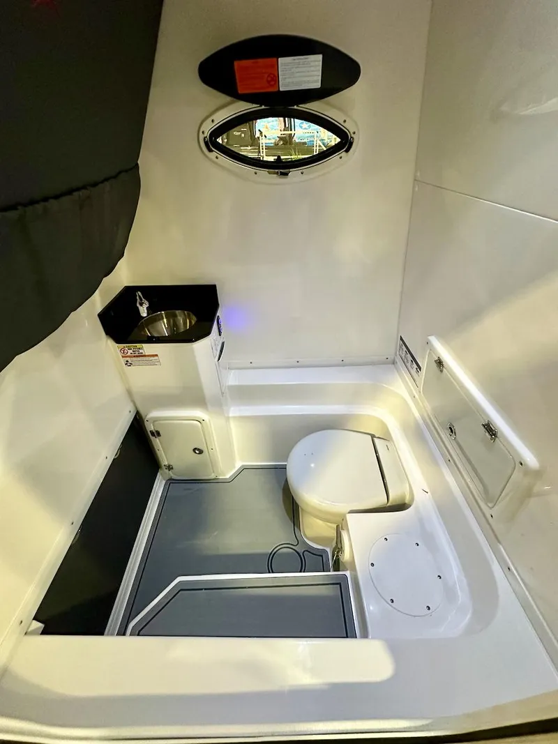 Slide: The Image of 2024 Glasstream 32 GSX boat interior with compact bathroom and sink. - 21