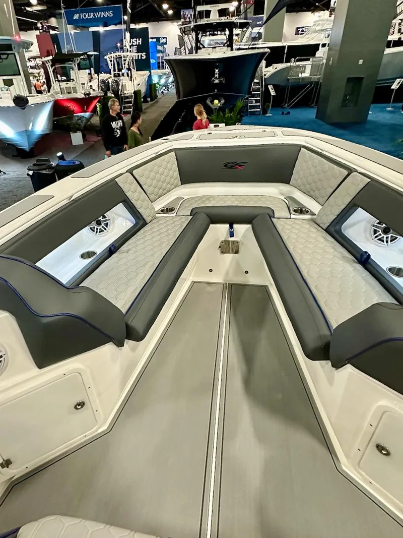 Slide: The Image of 2024 Glasstream 32 GSX boat interior with cushioned seating at a boat show. - 5