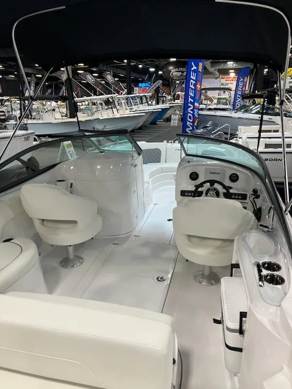 Slide: The Image of 2024 SouthWind 2400 SD boat interior with white seating and dashboard. - 5
