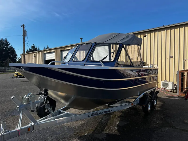 Slide: The Image of 2024 Thunder Jet 20 Chinook OS boat on trailer outside a warehouse. - 5