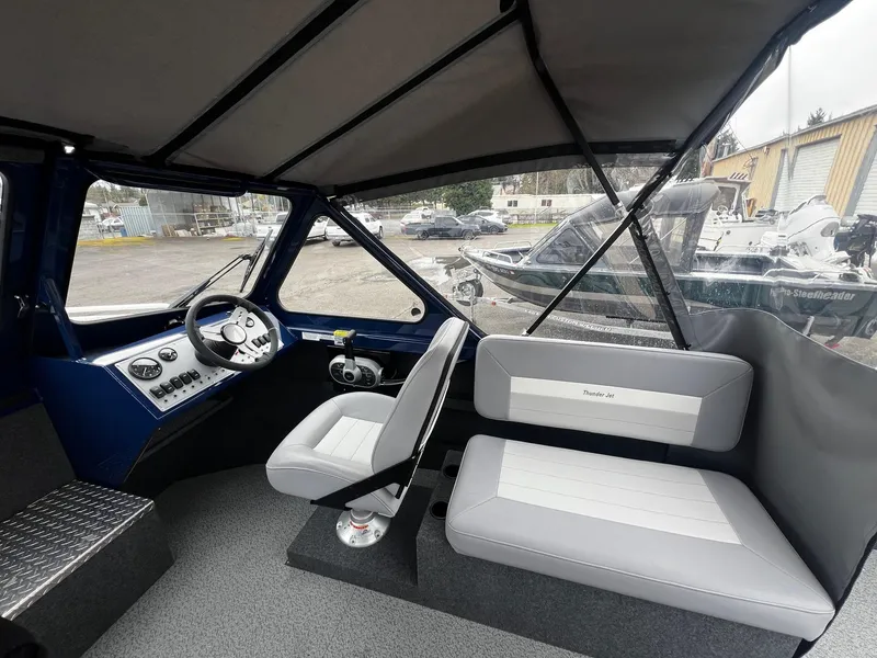 Slide: The Image of 2024 Thunder Jet 20 Chinook OS boat interior with seating and steering console. - 7