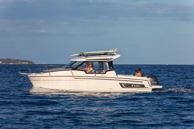 Slide: The Image of 2024 Jeanneau NC 795 Weekender S2 cruising on open water. - 11