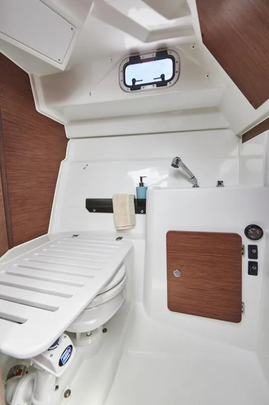 Slide: The Image of 2024 Jeanneau NC 795 Weekender S2 boat interior with compact bathroom and porthole window. - 30