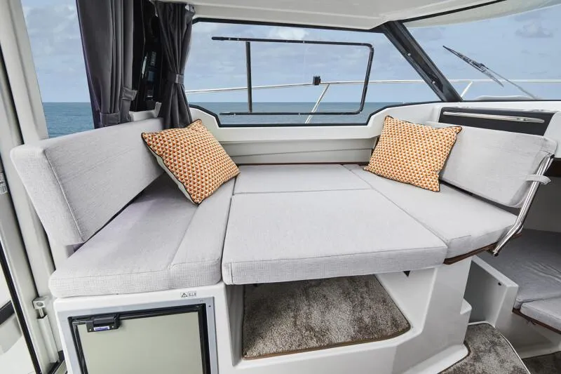 Slide: The Image of Interior seating area of 2024 Jeanneau NC 795 Weekender S2 boat with cushions. - 34