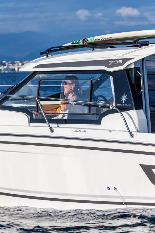Slide: The Image of 2024 Jeanneau NC 795 Weekender S2 cruising on water with passengers. - 6