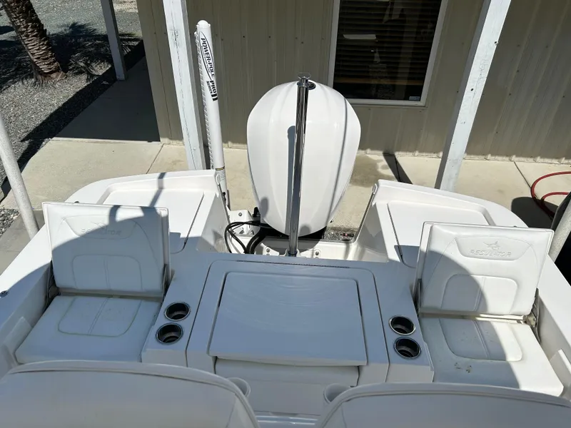 Slide: The Image of 2020 Regulator 26XO boat stern view with seating and outboard motor. - 10