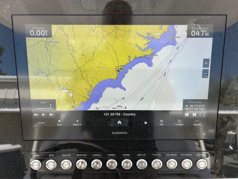 Slide: The Image of Garmin navigation display on 2020 Regulator 26XO boat, showing coastal map and controls. - 14