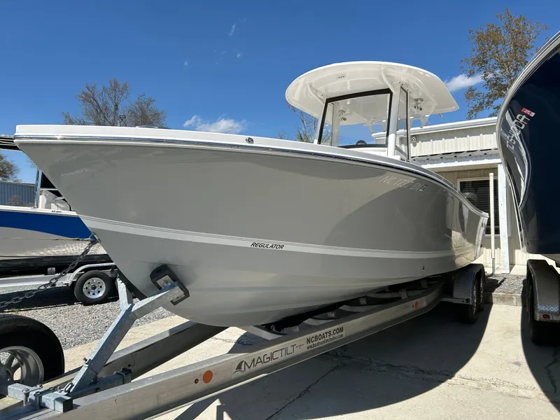 Slide: The Image of 2020 Regulator 26XO boat on trailer, displayed outdoors under clear sky. - 17