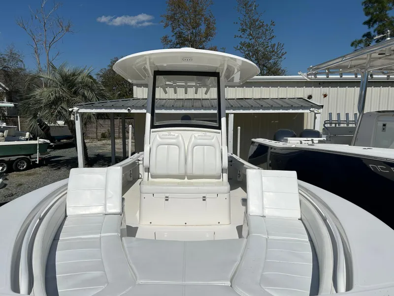 Slide: The Image of 2020 Regulator 26XO boat with spacious seating, docked outdoors under clear skies. - 18