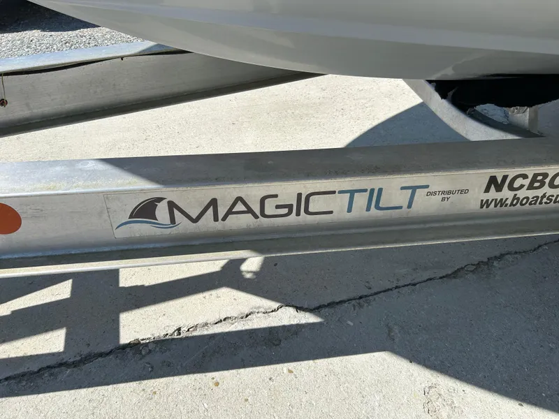 Slide: The Image of Magic Tilt boat trailer for 2020 Regulator 26XO, shown on concrete surface. - 19