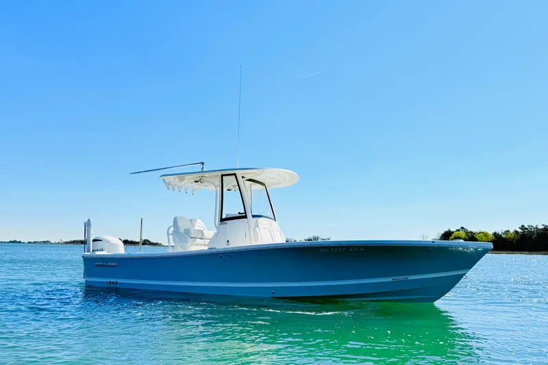 Slide: The Image of 2020 Regulator 26XO boat on clear blue water under a sunny sky. - 2