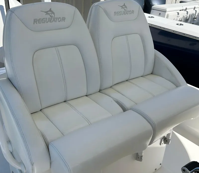 Slide: The Image of 2020 Regulator 26XO boat seats, white leather, dual seating arrangement. - 23