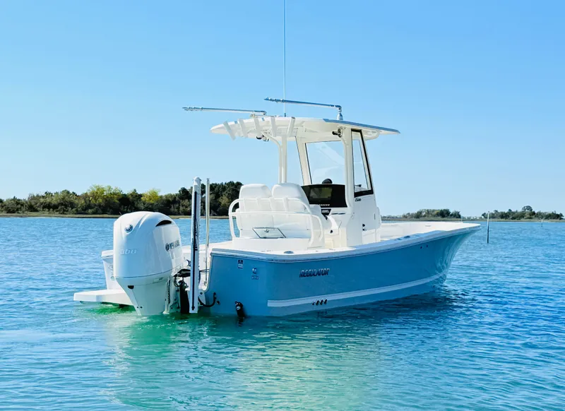 Slide: The Image of 2020 Regulator 26XO boat on calm water under clear blue sky. - 3