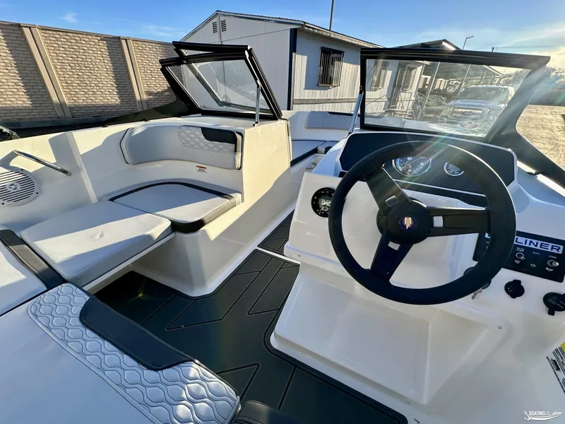 Slide: The Image of 2025 Bayliner M17 boat interior with steering wheel and seating area. - 10