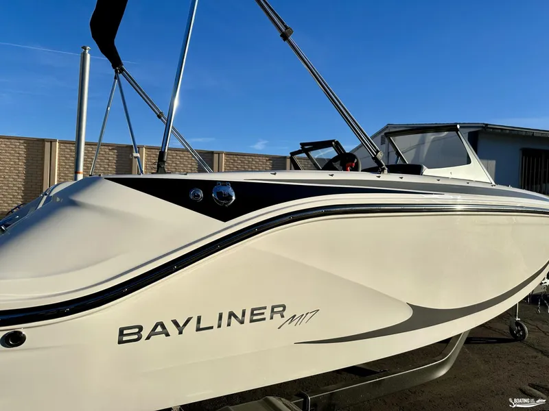 Slide: The Image of 2025 Bayliner M17 boat in sunlight, showcasing sleek design and branding. - 2