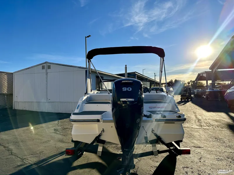 Slide: The Image of 2025 Bayliner M17 boat with Mercury 90 engine in sunny marina setting. - 4