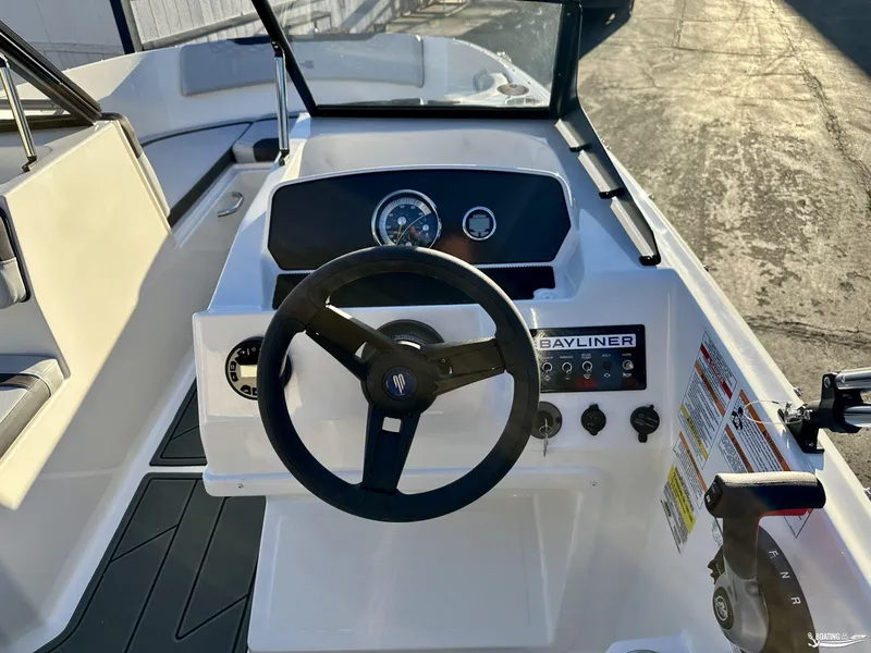 Slide: The Image of 2025 Bayliner M17 boat dashboard with steering wheel and control panel. - 9