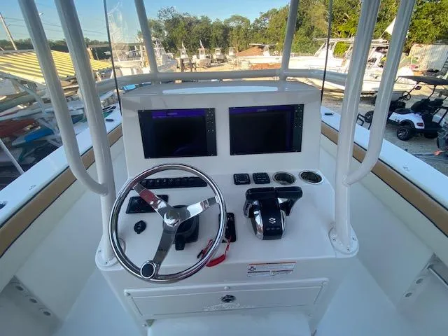 Slide: The Image of 2023 Sea Chaser 30 boat helm with dual screens and steering wheel. - 4