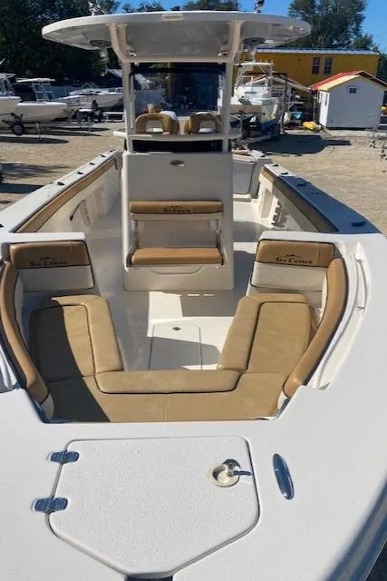 Slide: The Image of 2023 Sea Chaser 30 boat with tan seating and white deck in a marina. - 5