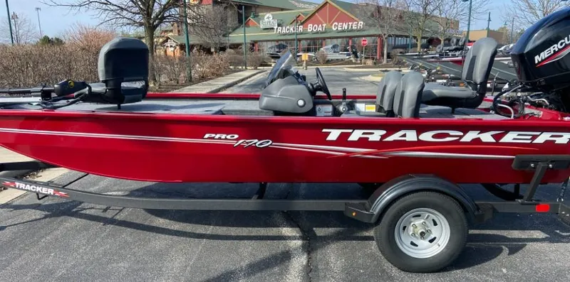 Slide: The Image of 2024 Tracker Pro 170 boat in red, parked at Tracker Boat Center. - 3
