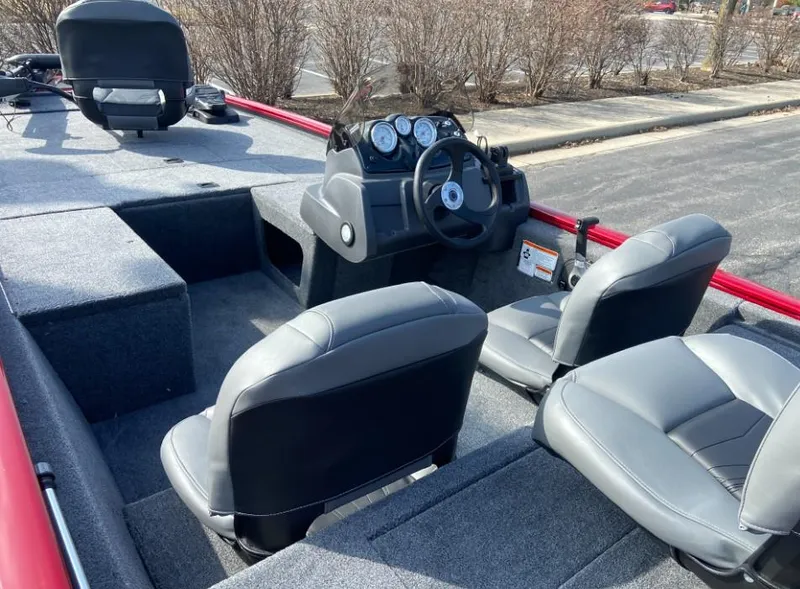 Slide: The Image of 2024 Tracker Pro 170 boat interior with gray seats and steering console. - 4