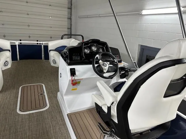 Slide: The Image of 2024 JC Spirit 221 TT Sport boat interior with captain's chair and control console. - 14