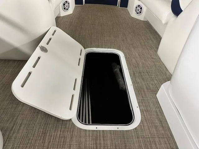 Slide: The Image of 2024 JC Spirit 221 TT Sport boat interior with open storage compartment. - 11