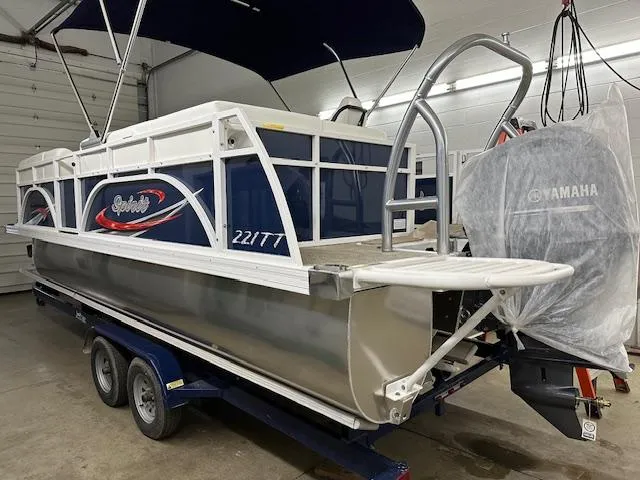 Slide: The Image of 2024 JC Spirit 221 TT Sport pontoon boat in a garage with Yamaha outboard motor. - 12
