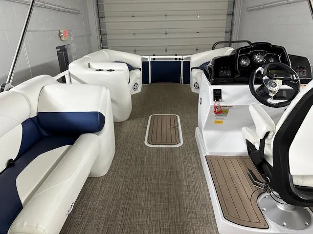 Slide: The Image of 2024 JC Spirit 221 TT Sport boat interior with white and blue seating. - 13