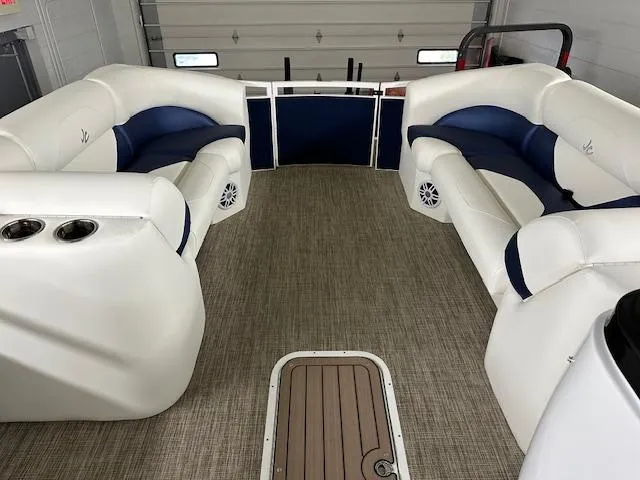 Slide: The Image of 2024 JC Spirit 221 TT Sport boat interior with white and blue seating. - 16