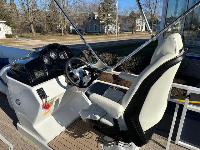 Slide: The Image of 2024 JC Spirit 221 TT Sport boat helm with captain's chair and control panel. - 4