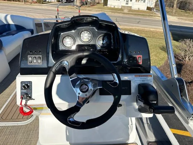 Slide: The Image of 2024 JC Spirit 221 TT Sport boat dashboard with steering wheel and controls. - 5