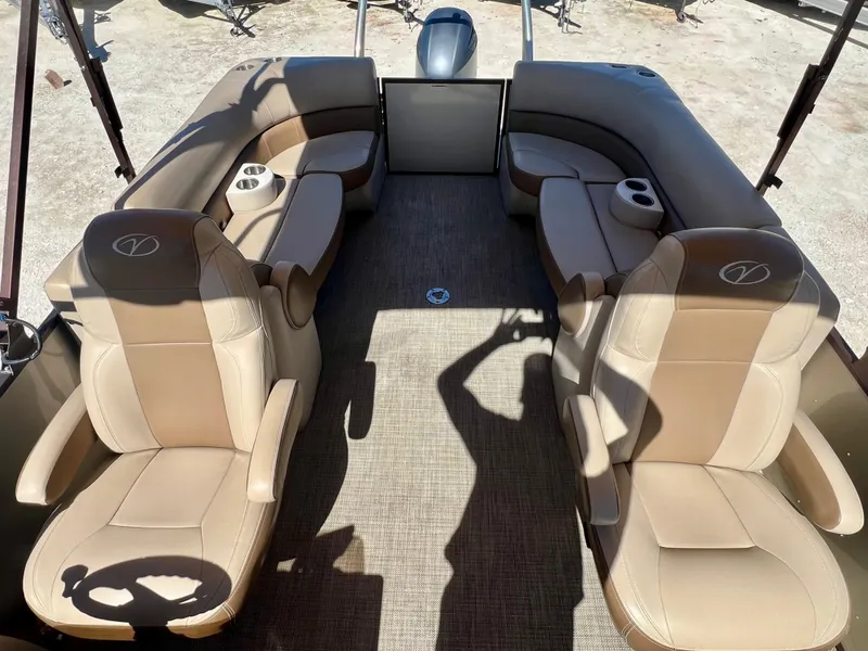 Slide: The Image of 2016 Crest Veranda V2275RC boat interior with tan leather seats and cup holders. - 13