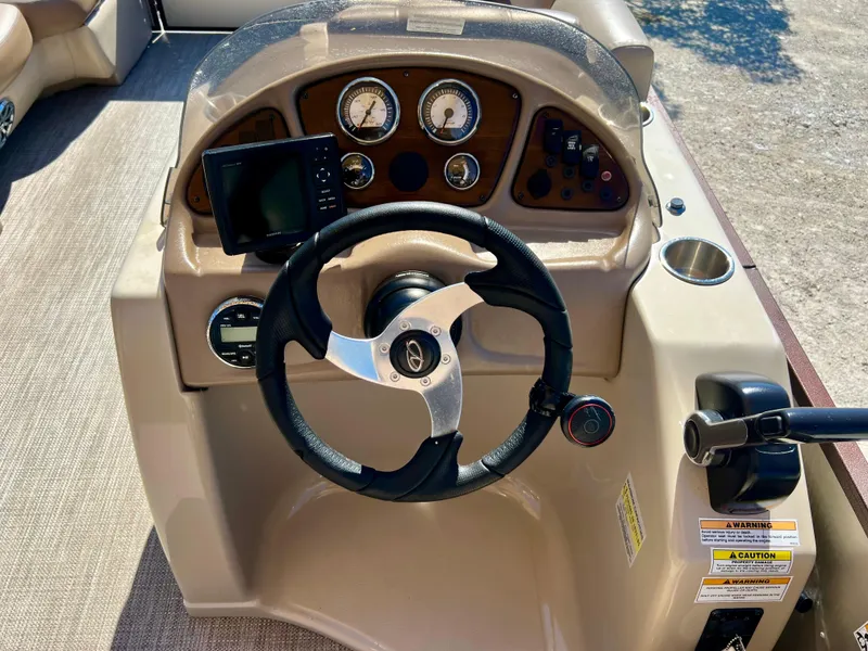 Slide: The Image of 2016 Crest Veranda V2275RC boat dashboard with steering wheel and control panel. - 16