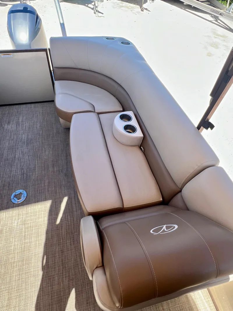 Slide: The Image of 2016 Crest Veranda V2275RC boat interior seating with cup holders. - 21