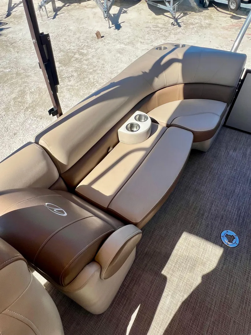 Slide: The Image of 2016 Crest Veranda V2275RC boat interior with tan leather seating and cup holders. - 22