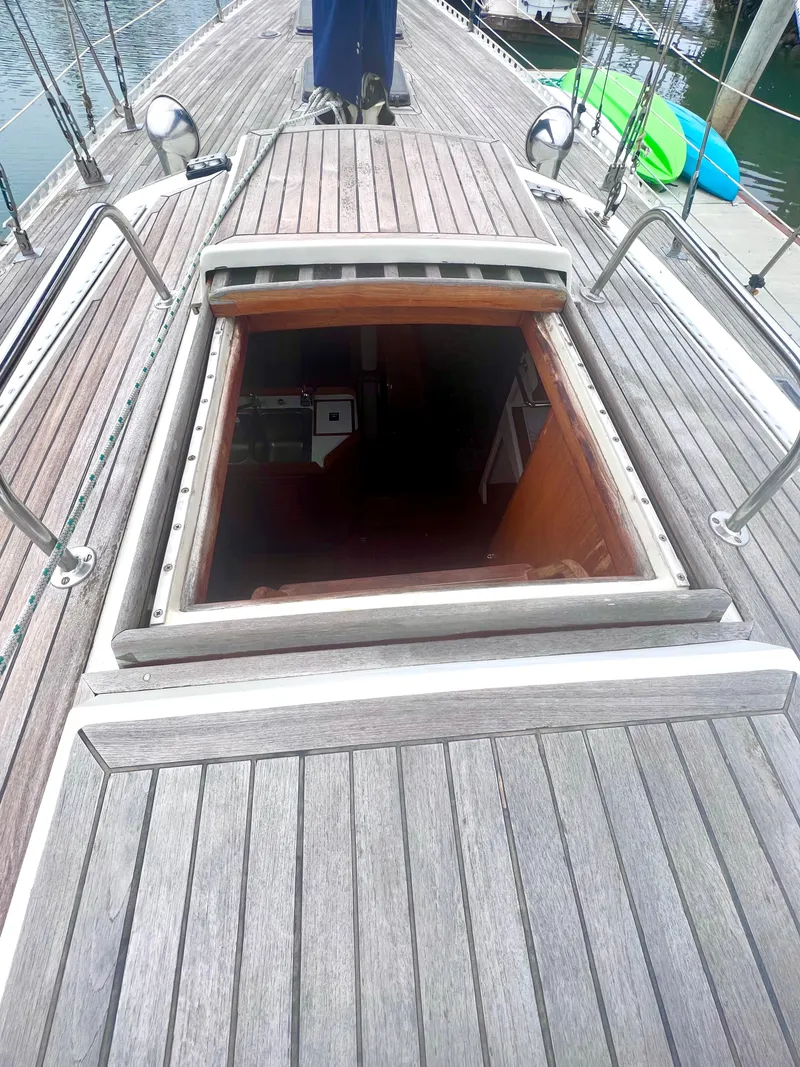 Slide: The Image of 1980 Lafitte 44 sailboat deck with open hatch, revealing interior cabin. - 17