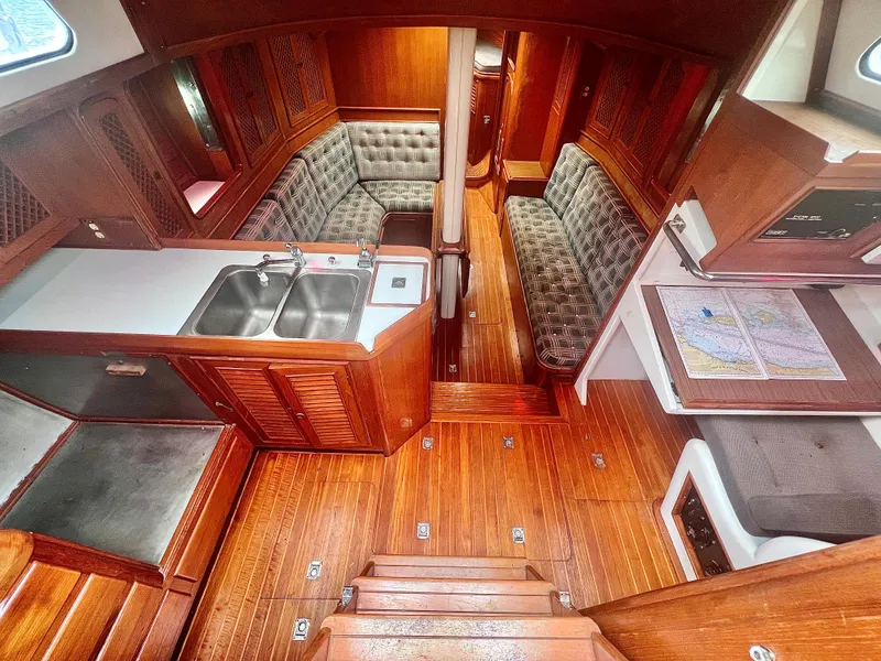 Slide: The Image of Interior of a 1980 Lafitte 44 sailboat with wood finish and cozy seating. - 18