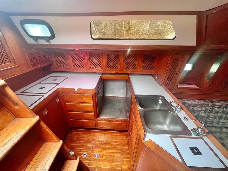 Slide: The Image of Interior of 1980 Lafitte 44 sailboat with wooden cabinetry and dual sinks. - 19