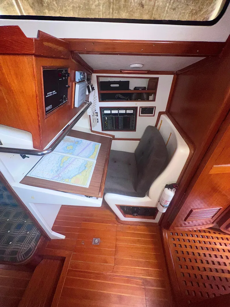 Slide: The Image of Navigation station inside 1980 Lafitte 44 sailboat with chart table and control panel. - 22