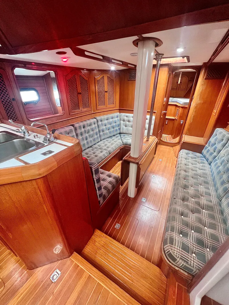 Slide: The Image of 1980 Lafitte 44 yacht interior with wood finish and cushioned seating. - 24