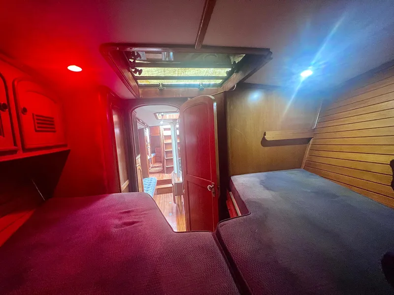 Slide: The Image of Interior of 1980 Lafitte 44 sailboat with cozy cabin and ambient lighting. - 29