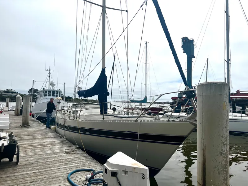 Slide: The Image of 1980 Lafitte 44 sailboat docked at marina with overcast sky. - 4