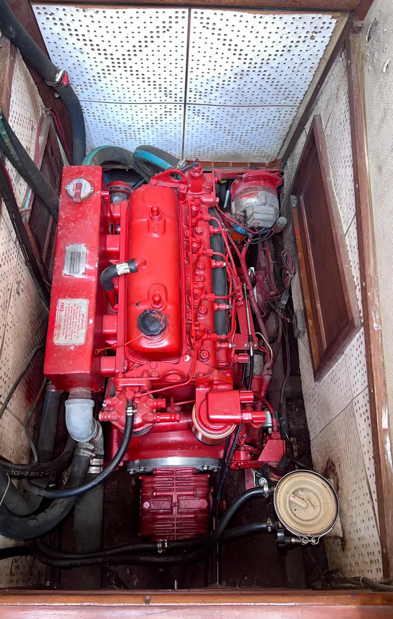 Slide: The Image of Red engine inside a 1980 Lafitte 44 boat, showcasing detailed mechanical components. - 42