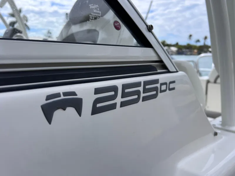 Slide: The Image of 2019 World Cat 255 DC boat speaker and control panel under blue canopy. - 20