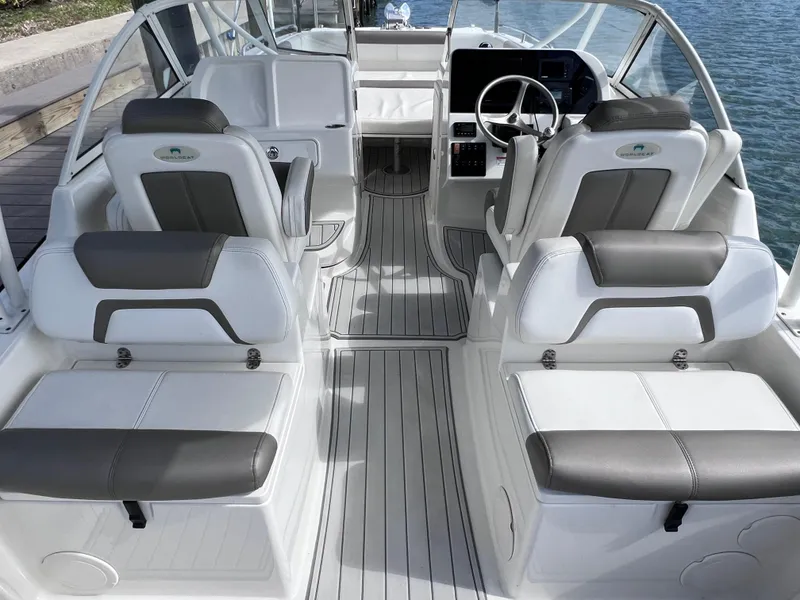 Slide: The Image of 2019 World Cat 255 DC boat interior with cup holders and cushioned seating. - 26