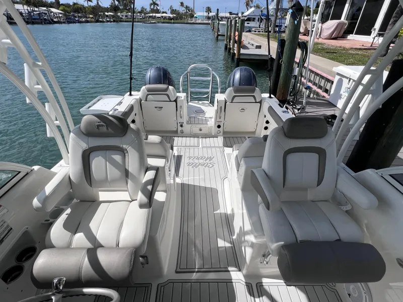 Slide: The Image of 2019 World Cat 255 DC boat interior with sleek white console and cup holders. - 33