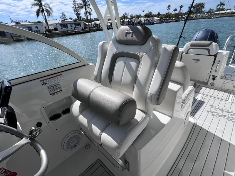 Slide: The Image of Helm console of a 2019 World Cat 255 DC boat by the water. - 35