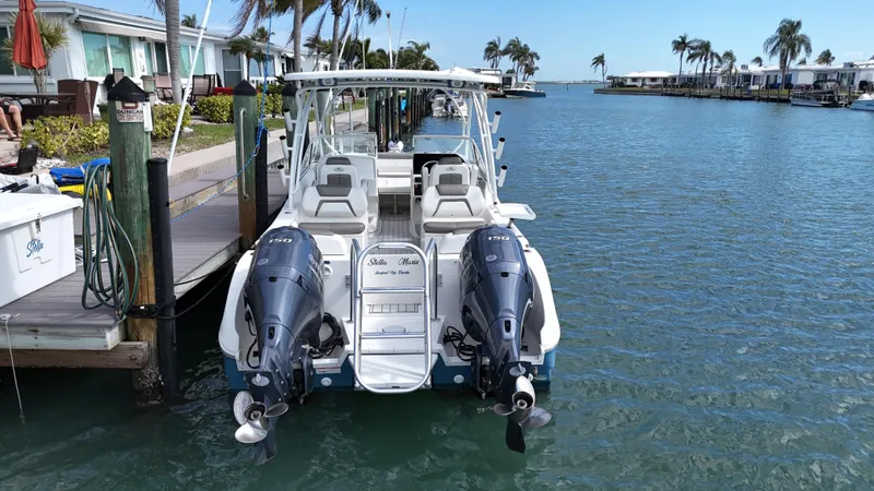 Slide: The Image of 2019 World Cat 255 DC boat on clear blue water, featuring dual Yamaha engines. - 4