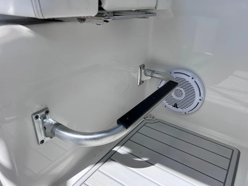 Slide: The Image of 2019 World Cat 255 DC boat interior with seating, docked on clear water. - 46